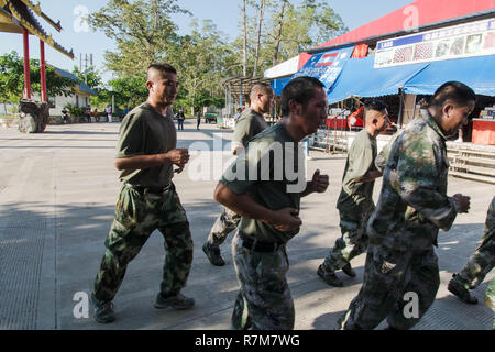 Laos traditional soldiers running Thai Stock Photo