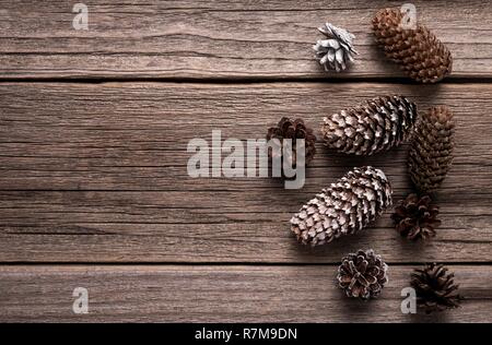 Cones are scattered on old wooden boards. Stock Photo