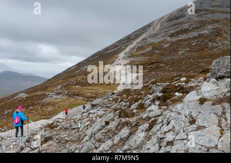 Republic of Ireland, County Mayo, Murrisk, Pilgrims climbing Croagh Patrick mountain Stock Photo