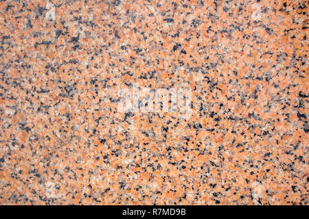 Orange granite stone background. Black, gray and orange colored granite texture. Stock Photo