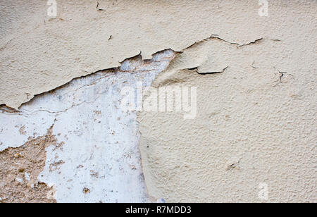 Old and weathered adobe wall with several layers of paint peeling off. Rustic background or texture with copy space. Stock Photo