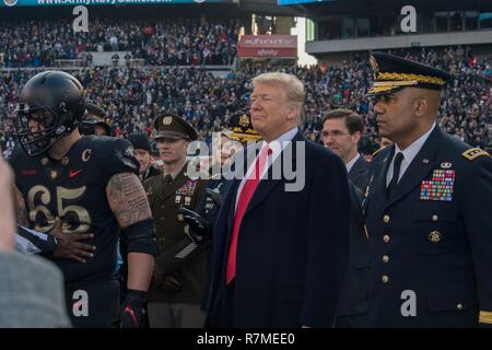 U.S President Donald Trump, center, with West Point Superintendent Lt. Gen. Darryl Williams, right, on the field for the coin toss before the start of the 119th Army Navy game at Lincoln Financial Field December 8, 2018 in Philadelphia, Pennsylvania. Stock Photo