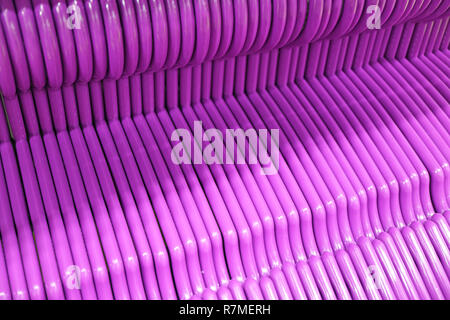 Lined Up Empty Vibrant Purple Clothes Hangers Stock Photo
