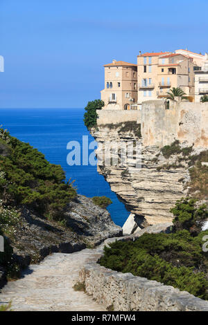 Houses on steep cliff with overhang in Bonifacio, Island of Corsica, France. Mediterranean sea. Stock Photo