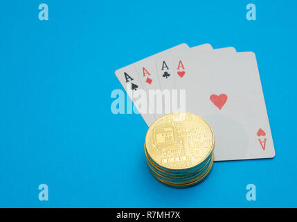 stack pile of cryptocurrency on playing cards. internet online casino gambling concept. close-up shot on blue background Stock Photo
