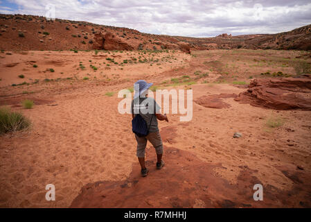 The Native American Navajo guide and owner at Waterhole Canyon - a slot canyon cutting through the red Navajo sandstone rocks near Page, Arizona, USA Stock Photo