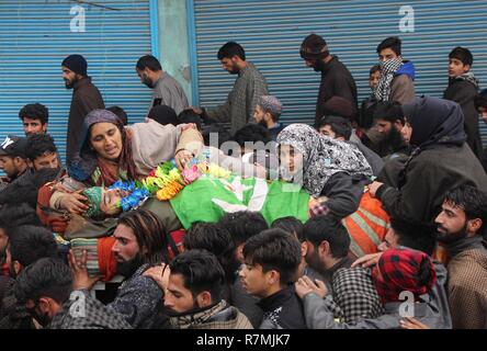 Hajin, Kashmir. 10th December, 2018. (EDITORS NOTE: Image depicts death) Mother and sisters of a teenage militant Sakib Bilal sit next to the dead body during the funeral ceremony in Hajin area of north Kashmir some 35 kilometers from Srinagar the summer capital of Indian controlled Kashmir on December 10, 2018. Fourteen year old was among the three militants killed in 18-hour long gun-battle in Mujigund area on the Srinagar outskirts on December 09, 2018. Credit: Faisal Khan/Pacific Press/Alamy Live News