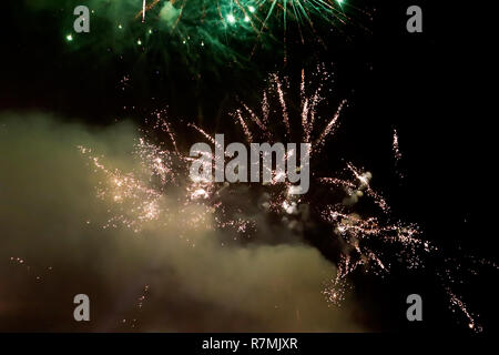 Abstract colored firework  on the night sky with smoke and free space for text, New Year celebration Stock Photo