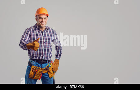 Repairman smiling in special clothes with tools. Stock Photo