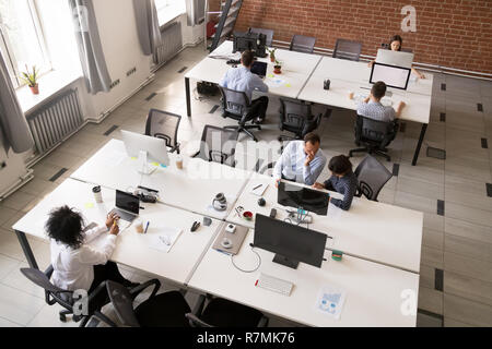 Employees working together in modern open office space Stock Photo