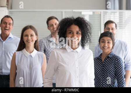 African American leader, coach posing with multiracial group of  Stock Photo
