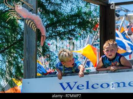 A young boy points at the Alma Bryant High School marching band lduring the 65th annual Blessing of the Fleet in Bayou La Batre, Alabama. Stock Photo