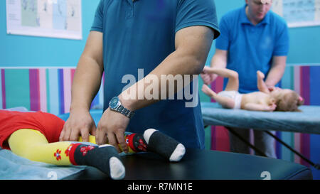 Medical clinic. An occupation with baby with cerebral palsy. A cabinet for physiotherapy Stock Photo