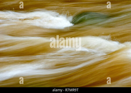 An abstract image of the Elliot Water in spate, shot with a slow shutter speed to blur the motion. Stock Photo