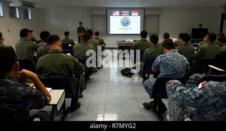 Pilots from the Royal Thai air force (RTAF), Republic of Singapore air force (RSAF), and U.S. Air Force (USAF) listen during a mission briefing for exercise Cope Tiger 2017 at Korat Royal Thai Air Force Base, Thailand, March 21, 2017. Over 1,200 U.S., Thai and Singaporean military members will participate in CT17. The annual multilateral exercise is aimed at improving combined combat readiness and interoperability between the RTAF, RSAF and USAF, while concurrently enhancing the three nations' military relations. Stock Photo