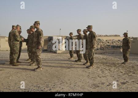 Brig. Gen. Alberto Rosende, commanding general of the 1st Mission Support Command, an Army Reserve unit based out of Fort Buchanan, Puerto Rico, puts the Garita patch on Soldiers during a patching ceremony for the 246th Quartermaster Company (Mortuary Affairs) at Camp Arifjan, Kuwait, on Mar. 20, 2017. Stock Photo