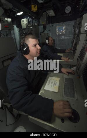 170320-N-ZE250-038   ATLANTIC OCEAN - (March 20, 2017) - Sonar Technician (Surface) 2nd Class Kevin Crawford, left, and Sonar Technician (Surface) 1st Class Mathew Nance operate the hull mounted sonar aboard USS Carney (DDG 64) while on patrol in the Atlantic Ocean March 20, 2017. Carney, an Arleigh Burke-class guided-missile destroyer, forward-deployed to Rota, Spain, is conducting its third patrol in the U.S. 6th Fleet area of operations in support of U.S. national security interests in Europe. (U.S. Navy photo by Mass Communication Specialist 3rd Class Weston Jones/Released) Stock Photo