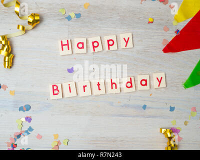 Happy Birthday Lettering with party decoration on wooden background, concept image, top view Stock Photo