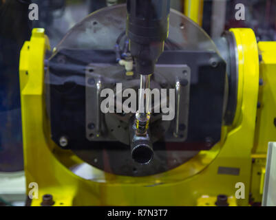 6 axis industry robotic arc machine welding nipple to pipe Stock Photo