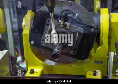 6 axis industry robotic arc machine welding nipple to pipe Stock Photo