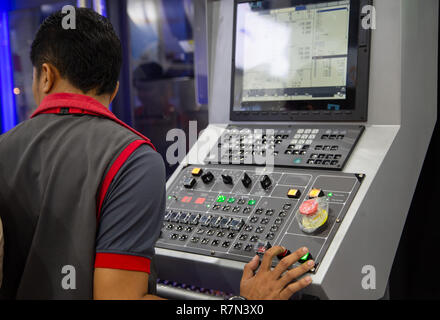 Industrial worker input data programing for CNC milling machine Stock Photo