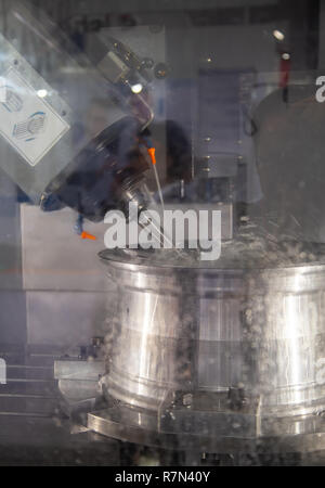 Car alloy wheel machining on CNC milling machine Stock Photo