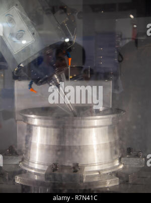 Car alloy wheel machining on CNC milling machine Stock Photo