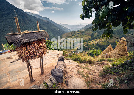 Beautiful scenic of village with corn storage and rice field in mountain valley in Himalayas, Nepal Stock Photo