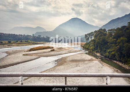 Foggy Mountains and river at Himalayas near Pokhara in Nepal Stock Photo