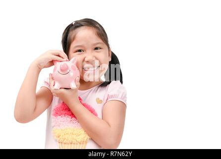 Happy cute asian girl holding pink piggy bank isolated on white background, saving money for education concept Stock Photo