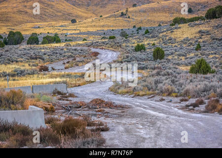 Unpaved road winding through a rugged wilderness Stock Photo