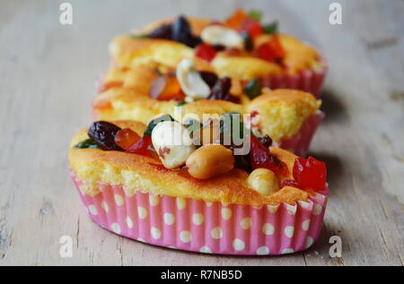 butter cupcake topping dries fruit and peanut on wooden background Stock Photo