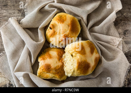Traditional Easter hot cross buns on wooden table Stock Photo