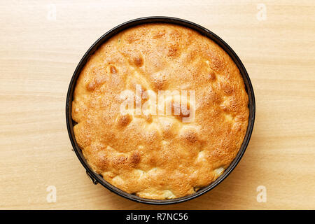 Homemade pastry charlotte pie with apples on wooden table. Top view. Stock Photo