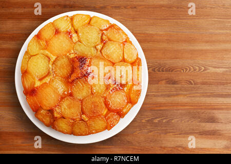 Homemade apple upside down cake on wooden table. Top view. Stock Photo