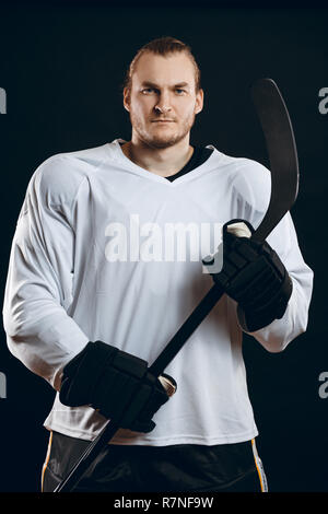 Handsome hockey player. Smiling at camera isolated on white Stock Photo