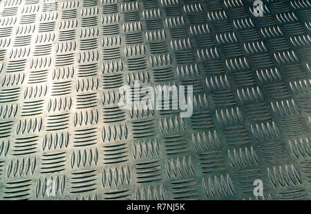 Industrial metal checker plate. Metal checker plate texture background. Metal checkerplate for anti skid. Embossed metal sheet floor. Silver bump grou Stock Photo