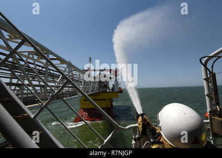 Fire fighting training exercises on the oil rig Lukoil Filanovsky at the Caspian sea, Russia. Stock Photo