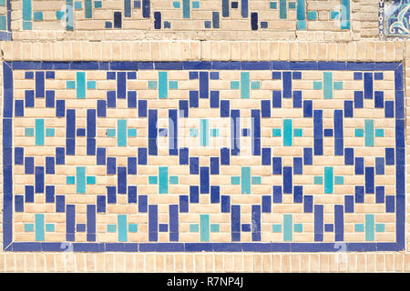 close up pattern of eastern, arabic ceramic, porcelain mosaic. Tiled background, oriental ornaments from Uzbekistan. Stock Photo