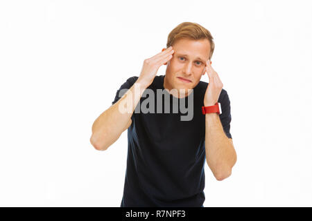 Cheerless sad young man feeling very miserable Stock Photo