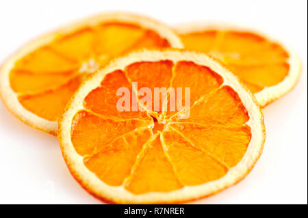 Three dried orange slices from above on white background Stock Photo