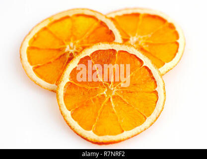 Three dried orange slices from above on white background Stock Photo