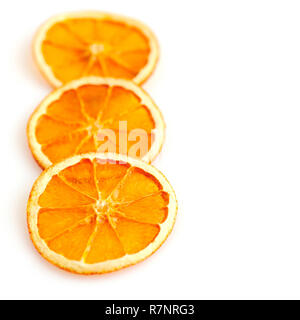 Three dried orange slices from above on white background Stock Photo
