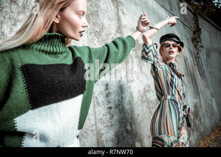 Blonde-haired and red-haired models collaborating and posing together Stock Photo