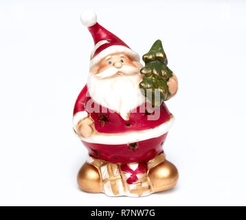 Cute Santa Claus doll. Adorable Santa Claus decorative toy, insulator on a white background. Christmas and New Year symbols. Stock Photo