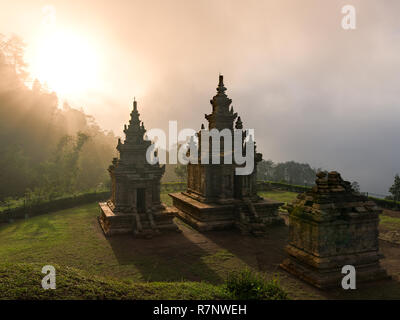 Candi Gedong Songo at sunrise. A 9th-century Buddhist temple complex on a volcano near Semarang, Java, Indonesia. Stock Photo