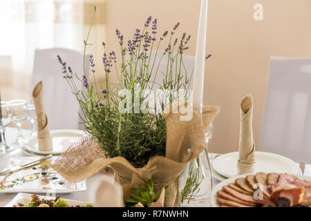 Wooden wedding table decoration with flowers and candles Stock Photo
