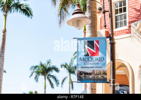 Naples, USA - April 30, 2018: Bayfront condos, condominiums colorful sign for McQuaid Company residential sales and rentals buildings with palm trees, Stock Photo