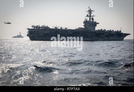 WATERS EAST OF THE KOREAN PENINSULA (March 22, 2017) The Nimitz-class aircraft carrier USS Carl Vinson (CVN 70) and the Arleigh Burke-class guided-missile destroyer USS Wayne E. Meyer (DDG 108) steam ahead of USS Stethem (DDG 63) during a surface maenuvers exercise with several other U.S. and Republic of Korea Navy ships and submarines during Foal Eagle (FE) 17. FE 17 is a series of annual training events designed to increase readiness to defend the ROK, protect the region, and maintain stability in the Korean Peninsula. Stock Photo