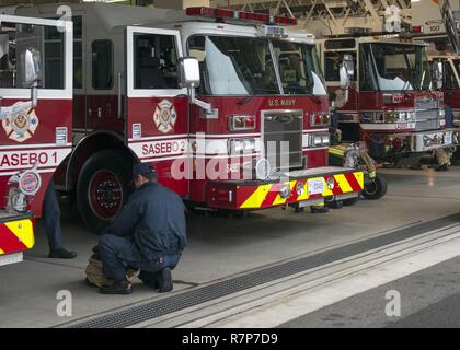 SASEBO, Japan (Mar. 29, 2017) Members of Commander Naval Forces Japan Fire and Emergency Services perform their daily morning fire apparatus check out onboard Commander U.S Fleet Activities Sasebo March 29, 2017. This daily exercise is conducted  to ensure operational readiness. Stock Photo